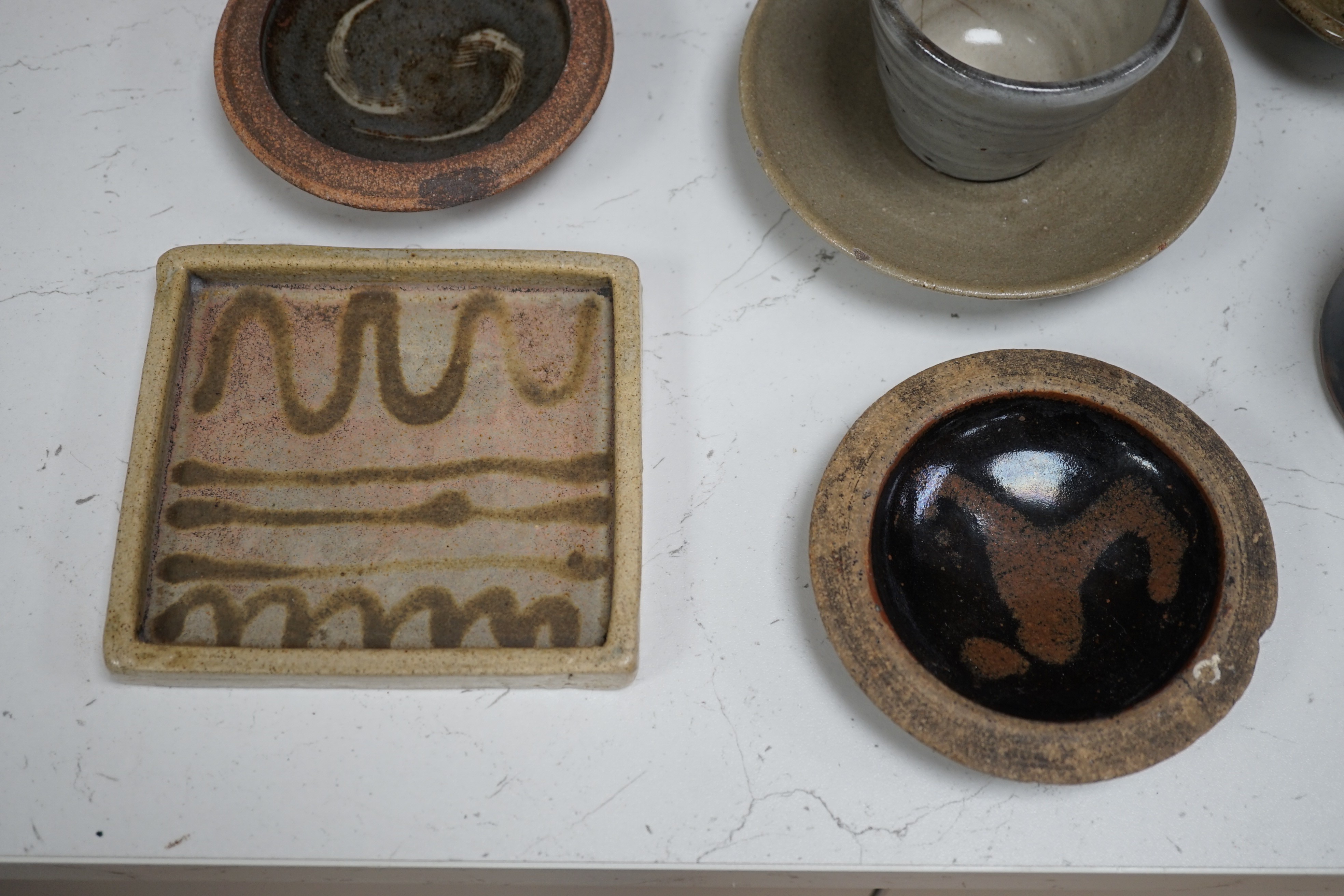 A group of studio pottery including St. Ives Leach pottery jug two dishes and a saucer